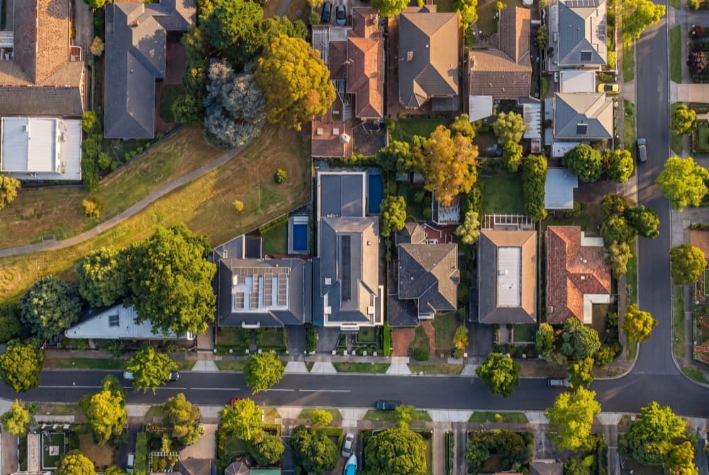A top down aerial of a suburban block at golden hour